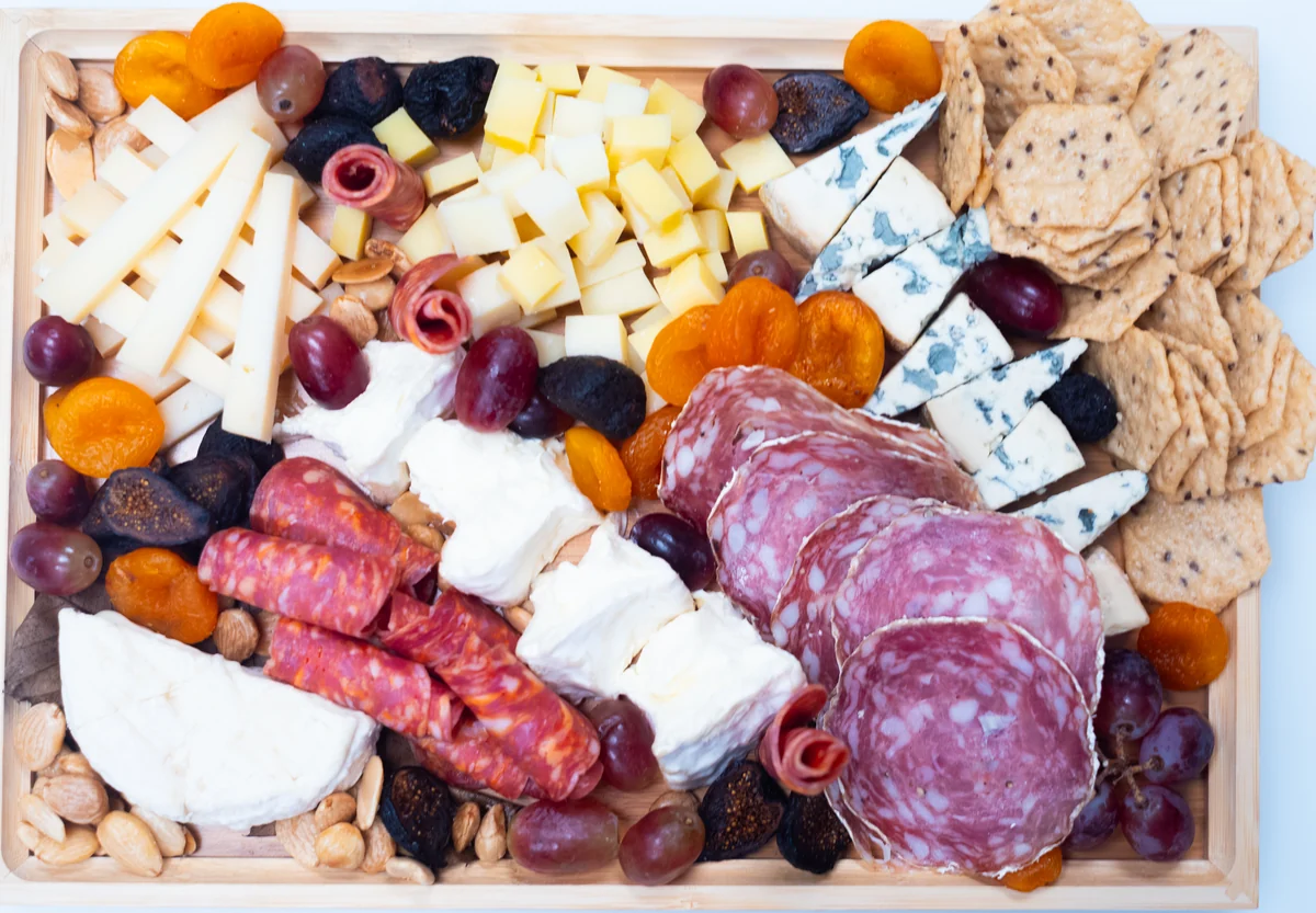 French Collection cheese board with charcuterie, crackers, fruit and nuts