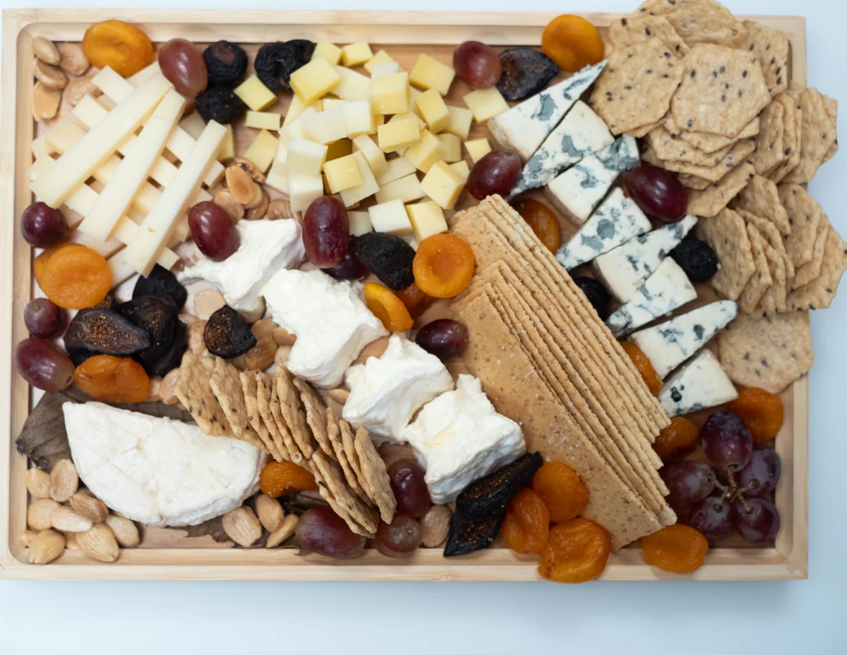 French Collection cheese board with cheeses, crackers, fruit and nuts